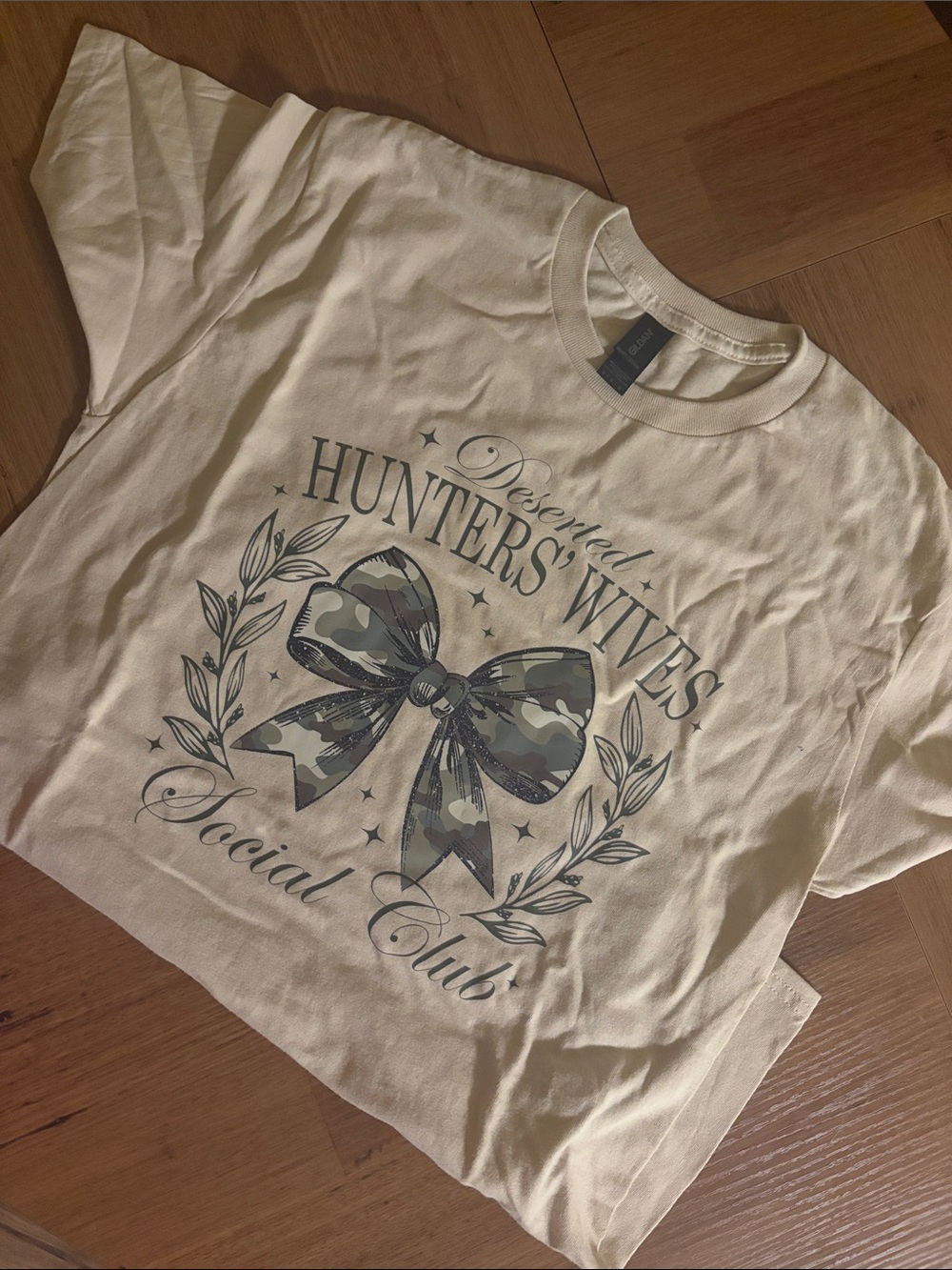 Deserted Hunters' Wives Social Club Graphic Tee - Cream with Camo Bow